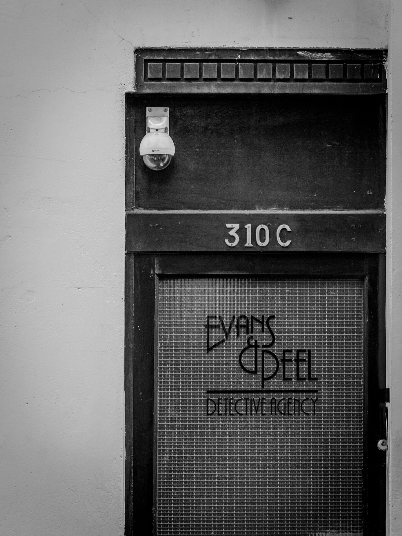 black wooden door with white wall